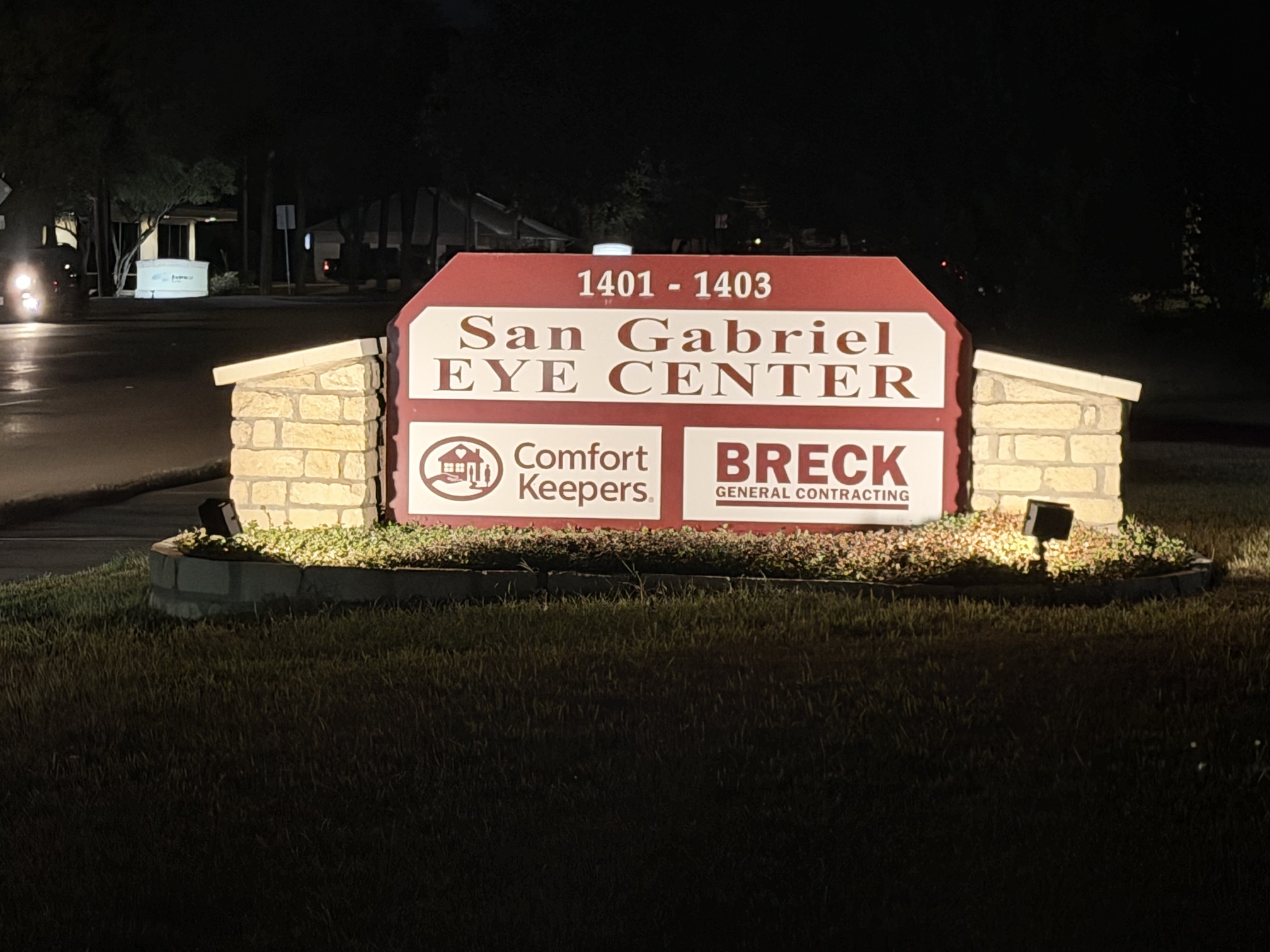Illuminated sign for San Gabriel Eye Center, showing the address 1401-1403, with additional logos for Comfort Keepers and Breck General Contracting.